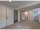 Finished basement area with painted white walls, wood-look floors and multiple entrances at 6454 Boca Grande Blvd, Forest Park, GA 30297