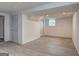 Spacious basement featuring neutral paint, wood-look floors, recessed lighting, and a window for natural light at 6454 Boca Grande Blvd, Forest Park, GA 30297