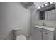 Bathroom featuring white cabinets, a modern sink, a toilet, and stylish vanity lighting at 6454 Boca Grande Blvd, Forest Park, GA 30297