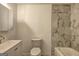 Bathroom with marble tile, vanity, toilet, sink, tub, and a shower at 6454 Boca Grande Blvd, Forest Park, GA 30297