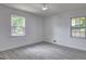 Well-lit bedroom featuring two large windows, neutral walls, and wood-look flooring at 6454 Boca Grande Blvd, Forest Park, GA 30297