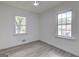 Bedroom with wood-look flooring, two large windows providing ample natural light at 6454 Boca Grande Blvd, Forest Park, GA 30297