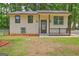 Charming home featuring a covered front porch, neutral siding, and well-maintained landscaping at 6454 Boca Grande Blvd, Forest Park, GA 30297
