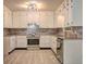 Bright kitchen featuring stainless steel appliances, granite countertops, and ample cabinet space at 6454 Boca Grande Blvd, Forest Park, GA 30297