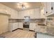 Bright kitchen featuring stainless steel appliances, granite countertops, and ample cabinet space at 6454 Boca Grande Blvd, Forest Park, GA 30297