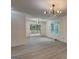 Bright living room with hardwood floors, modern lighting, and sliding doors to the outdoor deck at 6454 Boca Grande Blvd, Forest Park, GA 30297