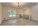 Open-concept living room featuring hardwood floors, modern lighting, and staircase at 6454 Boca Grande Blvd, Forest Park, GA 30297