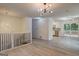 Open-concept living room featuring hardwood floors, modern lighting, and kitchen access at 6454 Boca Grande Blvd, Forest Park, GA 30297