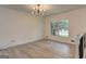 Bright living room featuring hardwood floors, modern lighting, and large windows at 6454 Boca Grande Blvd, Forest Park, GA 30297