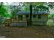 Back of home featuring a wooden deck, sliding glass doors, a well-maintained yard, and light yellow siding at 6454 Boca Grande Blvd, Forest Park, GA 30297