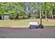 View of the backyard shows a storage shed, grill and patio on the rear of the property at 1310 Yarborough Dr, Peachtree City, GA 30269