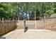 Outdoor area with a wooden fence, stone wall, and greenery, providing a private and serene backyard space at 1310 Yarborough Dr, Peachtree City, GA 30269