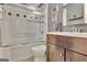 Bathroom with a dark vanity, tiled shower, and wood-look flooring at 1310 Yarborough Dr, Peachtree City, GA 30269
