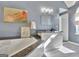 Bright bathroom featuring a soaking tub, gray walls, and modern fixtures at 1310 Yarborough Dr, Peachtree City, GA 30269
