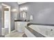 Bathroom with a soaking tub, granite counters, and white cabinetry at 1310 Yarborough Dr, Peachtree City, GA 30269
