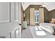 Inviting bedroom features neutral carpet, vaulted ceiling, and barn door to ensuite at 1310 Yarborough Dr, Peachtree City, GA 30269