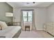 Bedroom has a trundle bed, neutral decor, and view of the backyard at 1310 Yarborough Dr, Peachtree City, GA 30269