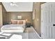 Bedroom features neutral carpet, vaulted ceiling, a fan, and painted walls at 1310 Yarborough Dr, Peachtree City, GA 30269