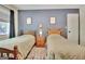 Bedroom with two beds, blue wall, and natural light from the window at 1310 Yarborough Dr, Peachtree City, GA 30269