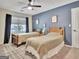 Bedroom featuring two twin beds, blue accent wall, and natural light at 1310 Yarborough Dr, Peachtree City, GA 30269