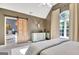 Well-lit bedroom with neutral carpet, vaulted ceiling, barn door, and ensuite at 1310 Yarborough Dr, Peachtree City, GA 30269