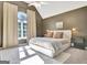 Sunlit bedroom features neutral carpet, vaulted ceiling, and a large window at 1310 Yarborough Dr, Peachtree City, GA 30269
