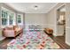 Colorful bonus room with a sofa, storage shelves, colorful rug, and natural light at 1310 Yarborough Dr, Peachtree City, GA 30269
