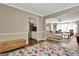 Bonus room with a colorful rug, hardwood floors, and access to living room at 1310 Yarborough Dr, Peachtree City, GA 30269