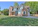 Beautiful two-story home featuring a well-maintained lawn and a driveway leading to the garage at 1310 Yarborough Dr, Peachtree City, GA 30269