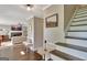 Open foyer view with stairs, hardwood floors, and a glimpse of the cozy living room at 1310 Yarborough Dr, Peachtree City, GA 30269