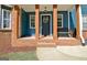 Inviting front porch featuring wooden pillars, a wreath, and a comfortable bench at 1310 Yarborough Dr, Peachtree City, GA 30269