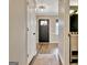 Hallway with wood floors leading to front door, and bathroom is accessible from the hallway at 1310 Yarborough Dr, Peachtree City, GA 30269