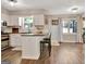 Charming kitchen with white cabinets, breakfast bar, hardwood floors, and stainless steel appliances at 1310 Yarborough Dr, Peachtree City, GA 30269