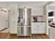 Bright kitchen featuring stainless steel refrigerator, white cabinets, and updated countertops at 1310 Yarborough Dr, Peachtree City, GA 30269