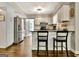 Bright kitchen featuring an island with seating, white cabinets, and modern appliances at 1310 Yarborough Dr, Peachtree City, GA 30269