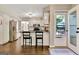 Bright kitchen featuring white cabinets, stainless steel appliances, breakfast bar, and backyard access at 1310 Yarborough Dr, Peachtree City, GA 30269