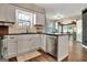 Modern kitchen with white cabinetry, stainless steel appliances, and wood-look flooring at 1310 Yarborough Dr, Peachtree City, GA 30269
