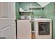 Laundry room with a washer, dryer, and shelving at 1310 Yarborough Dr, Peachtree City, GA 30269