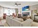 Cozy living room boasts a fireplace, large TV, and comfortable seating, perfect for relaxing and entertaining at 1310 Yarborough Dr, Peachtree City, GA 30269