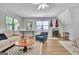 Bright living room features a comfortable couch and chair, complemented by natural light streaming through large windows at 1310 Yarborough Dr, Peachtree City, GA 30269