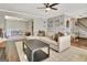 Bright living room features a comfortable beige sectional, stylish coffee table, and decorative wall art at 1310 Yarborough Dr, Peachtree City, GA 30269
