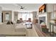 Bright and inviting living room with fireplace, a beige sectional, and a view of outdoor bay window at 1310 Yarborough Dr, Peachtree City, GA 30269