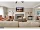 Comfortable living room featuring a brick fireplace, TV, and cozy seating arrangement at 1310 Yarborough Dr, Peachtree City, GA 30269