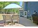 A spacious patio with an umbrella, seating, and lush green lawn at 1310 Yarborough Dr, Peachtree City, GA 30269