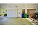 The carport features a door and window leading into the home, with trash cans staged nearby at 1655 Tryon Ne Rd, Brookhaven, GA 30319