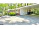Exterior view of a carport, showcasing the brick and siding detail with nearby landscaping at 1655 Tryon Ne Rd, Brookhaven, GA 30319