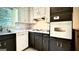 Kitchen with combination white and dark cabinetry and modern appliances at 1655 Tryon Ne Rd, Brookhaven, GA 30319
