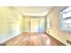 An empty living room featuring hardwood floors, windows, and a doorway with views into another room at 1655 Tryon Ne Rd, Brookhaven, GA 30319