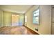 An empty living room featuring wood floors and a window that lets in natural light at 1655 Tryon Ne Rd, Brookhaven, GA 30319