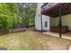 This backyard features a trampoline, wood fence, and a relaxing hot tub under the deck at 190 Ridgecrest Dr, Fayetteville, GA 30215